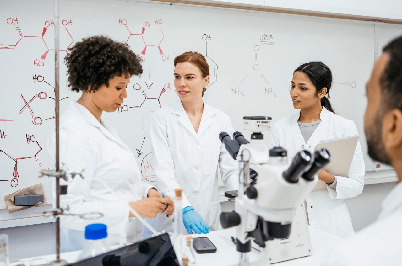 Scientists discussing research in a laboratory setting.