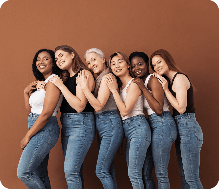 Women in jeans and tops, standing together.