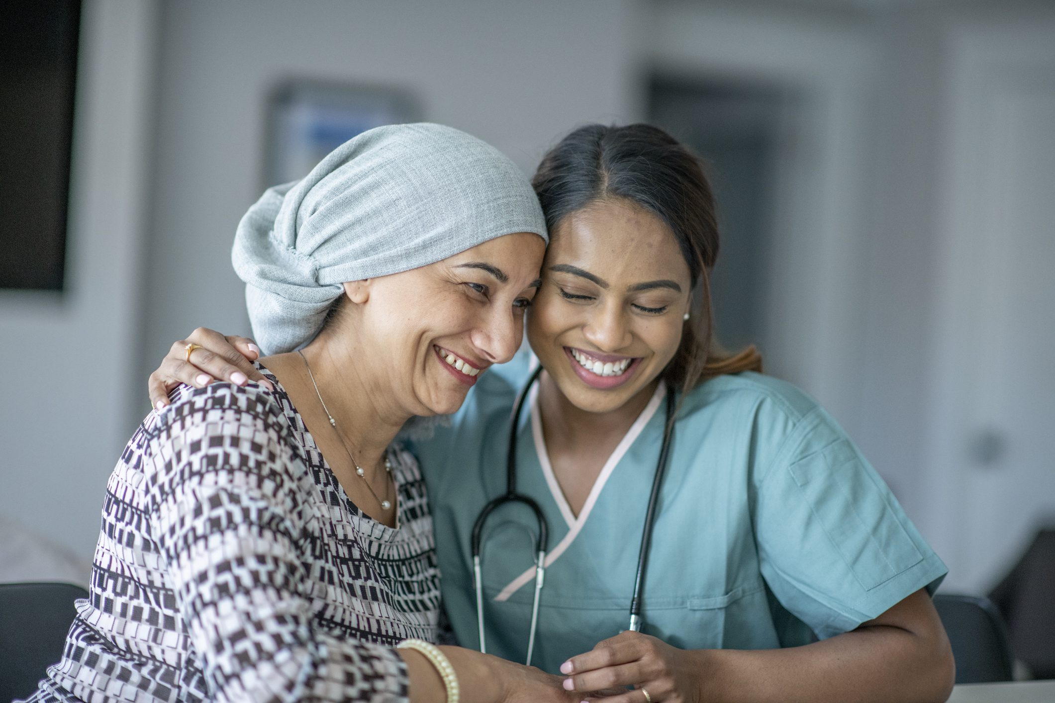 Patient and nurse sharing a joyful moment.