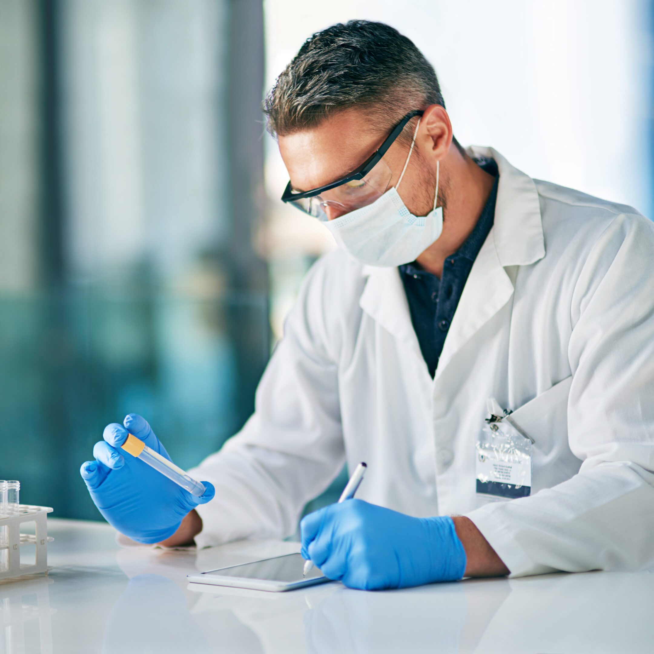 Scientist working in laboratory with tablet.